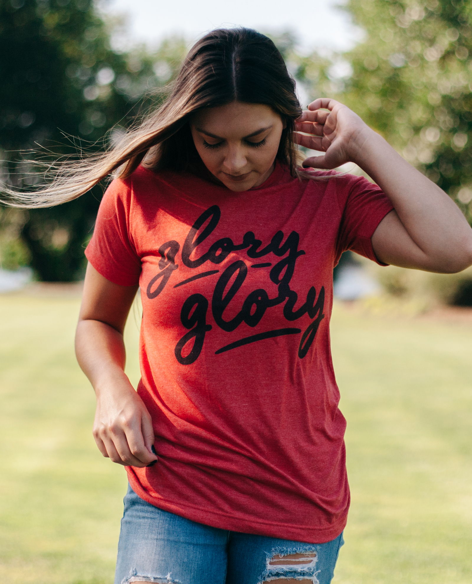 Woman wearing red Glory Glory shirt with jeans